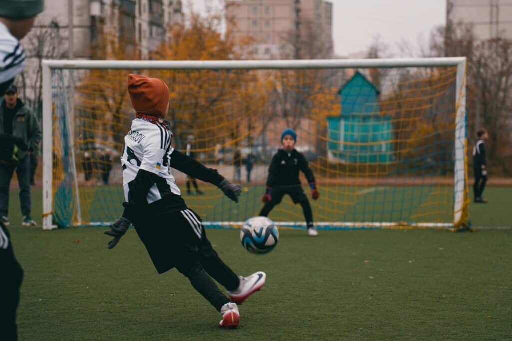 Kids playing football in the park